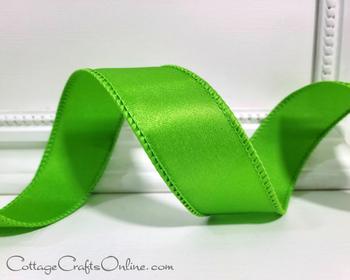 A green ribbon is sitting on top of a table.