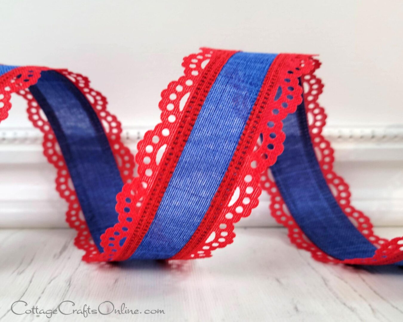 A red and blue ribbon sitting on top of a table.