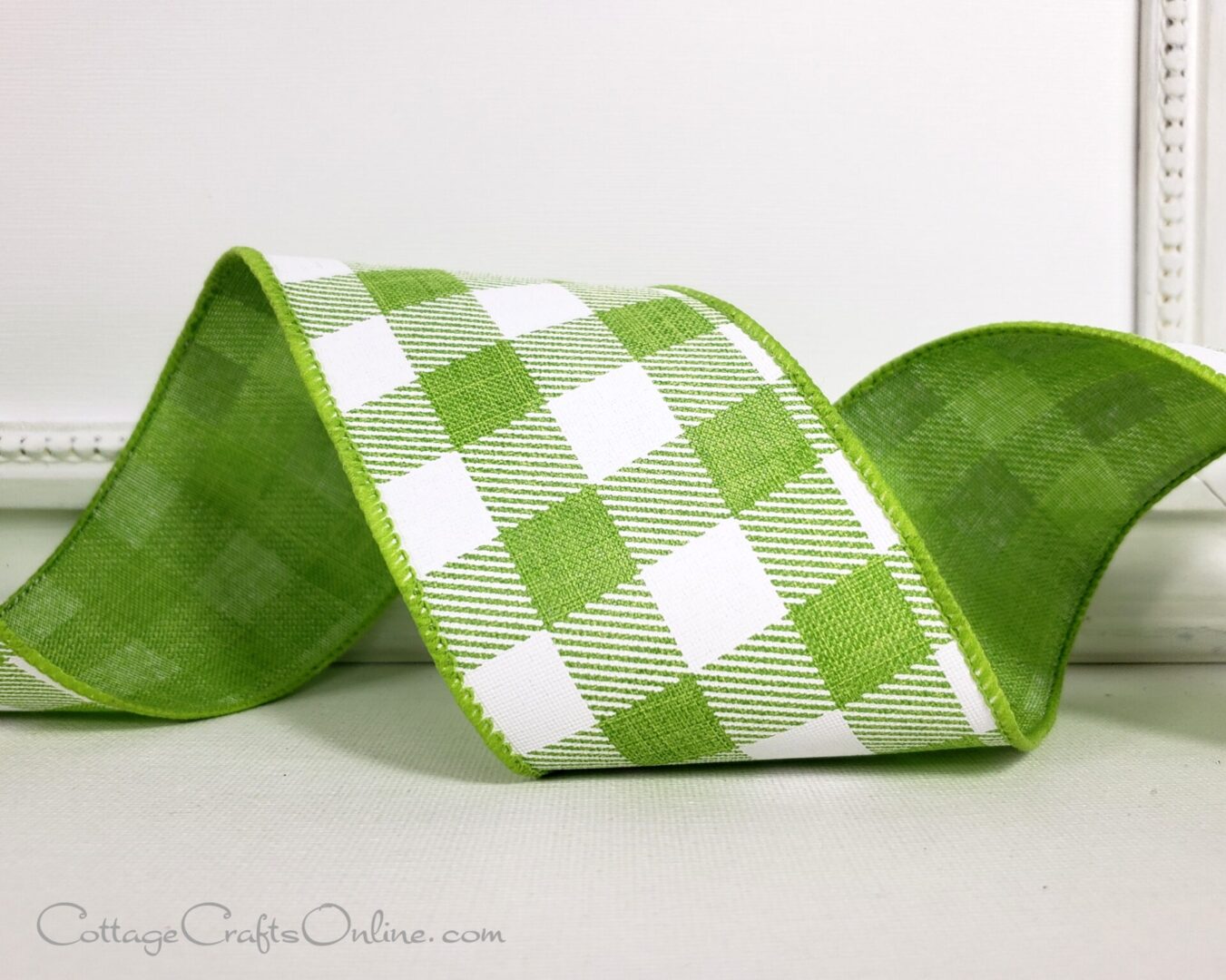 A green and white plaid ribbon sitting on top of a table.