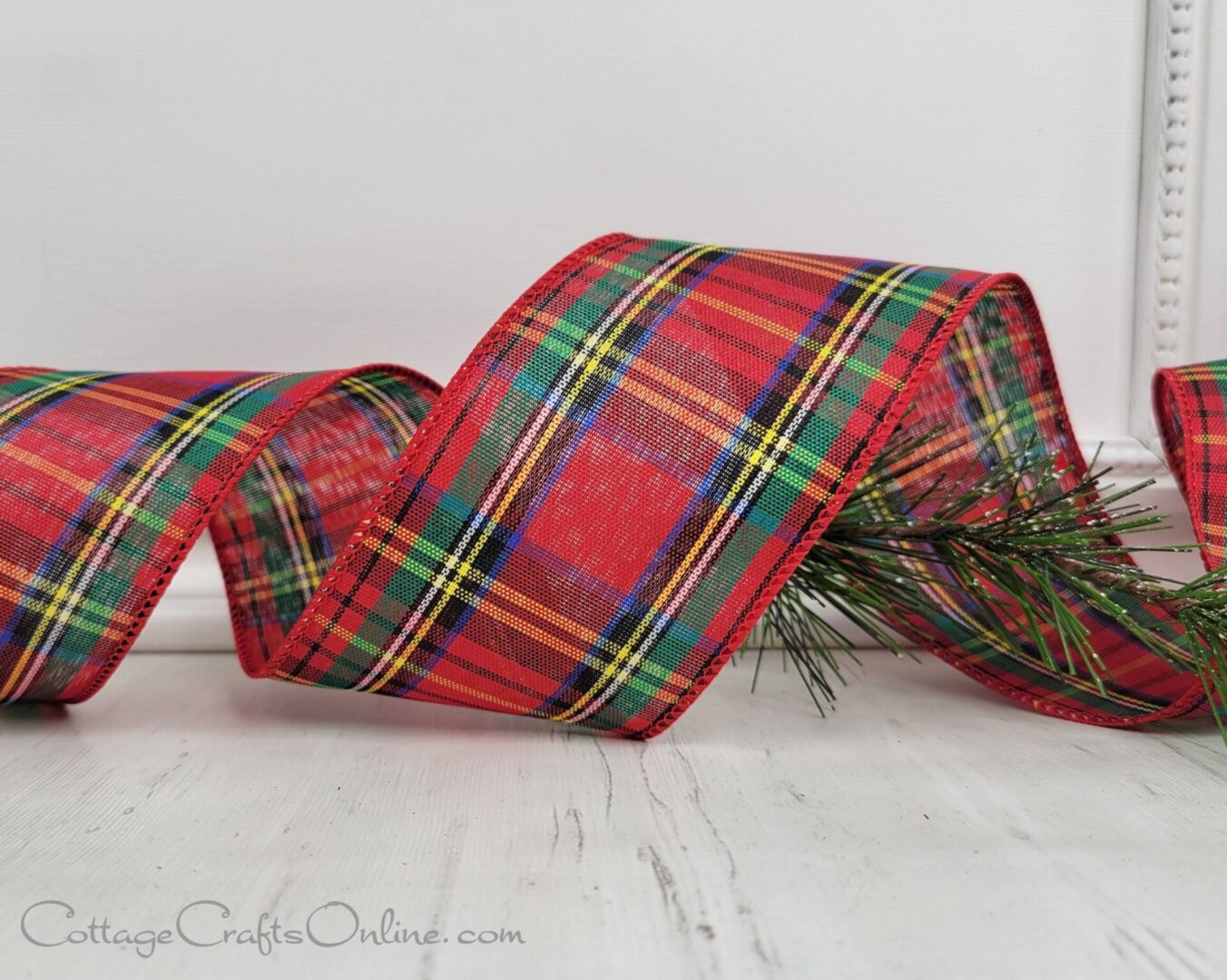 A red plaid ribbon sitting on top of a table.