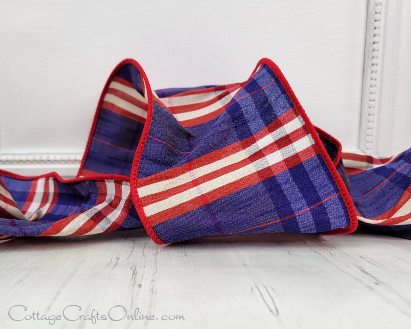 A folded blanket with red, white and blue stripes.