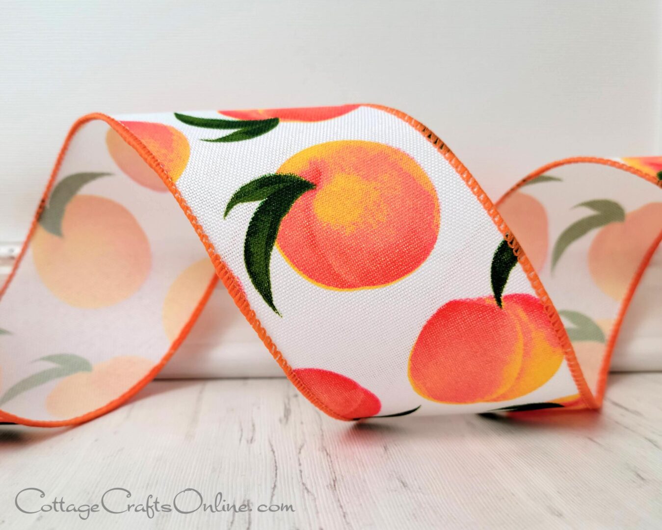 A close up of a ribbon with oranges on it
