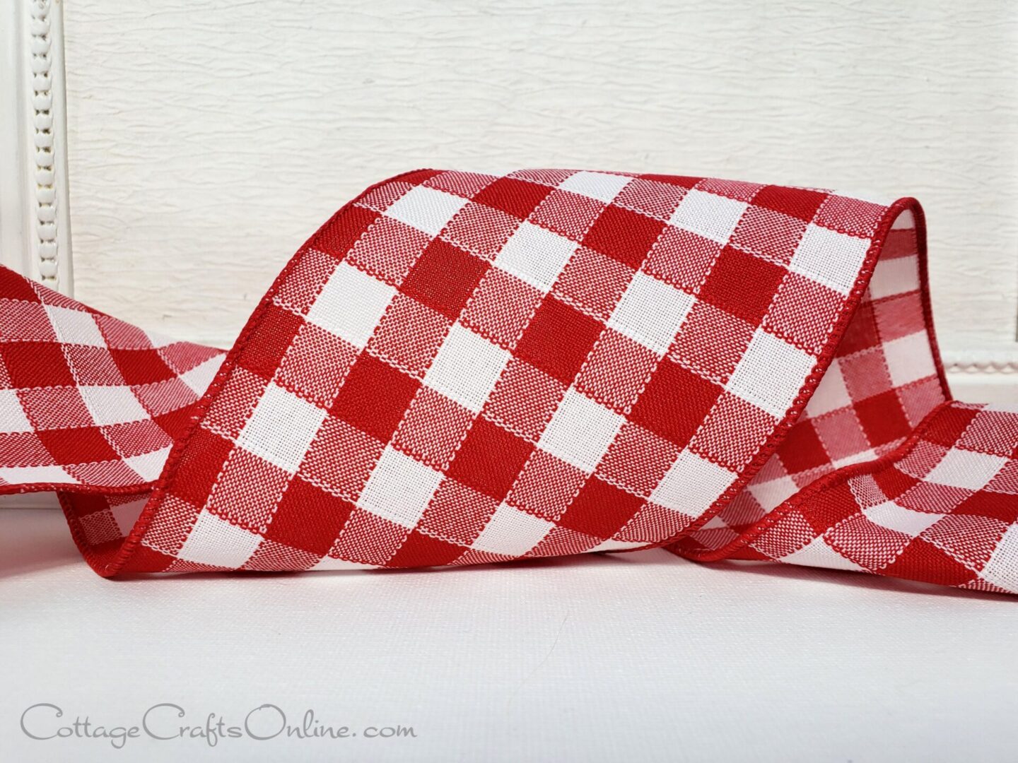A red and white checkered ribbon on a table.