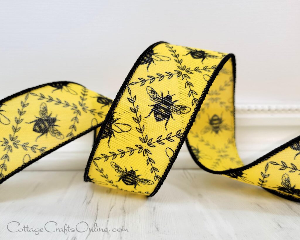 A yellow ribbon with black bees on it