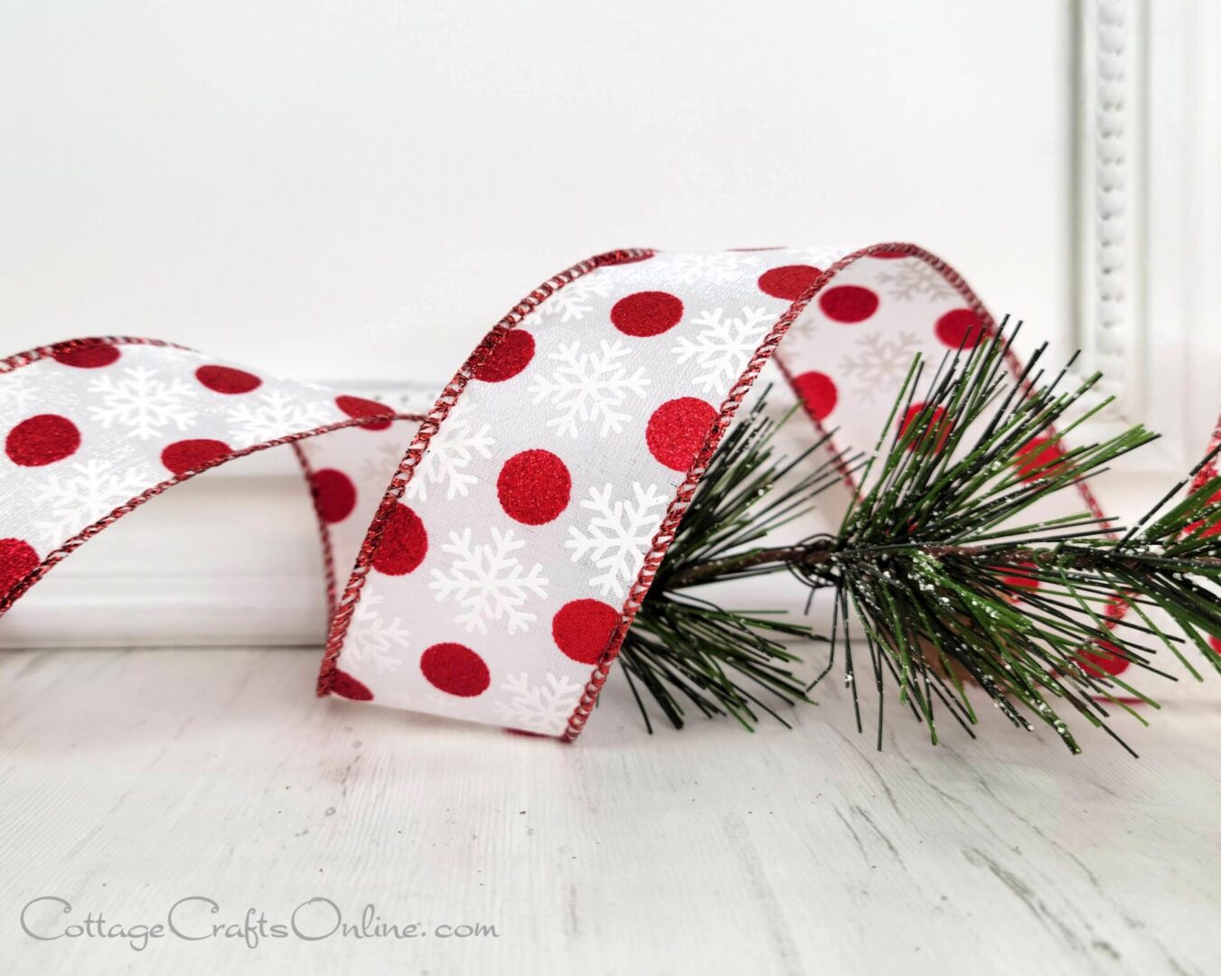 A red and white polka dot ribbon with snowflakes.