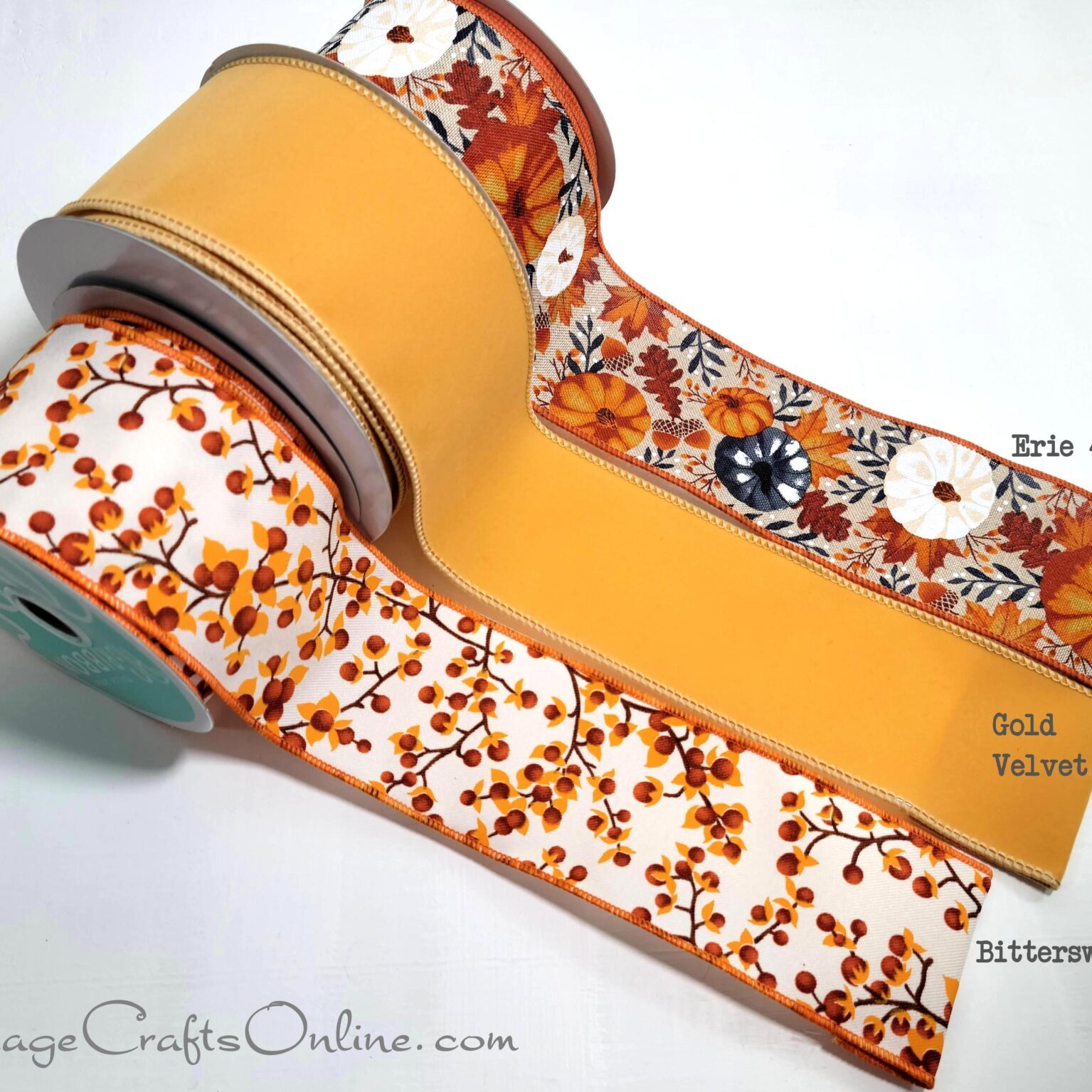 A group of three rolls of ribbon with different designs on them.