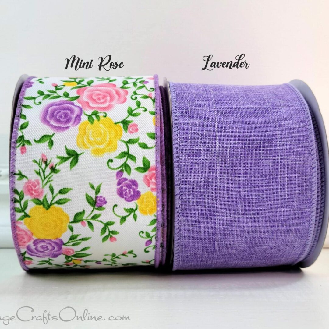 A purple ribbon with flowers on it and the same fabric as the ends of the ribbon.
